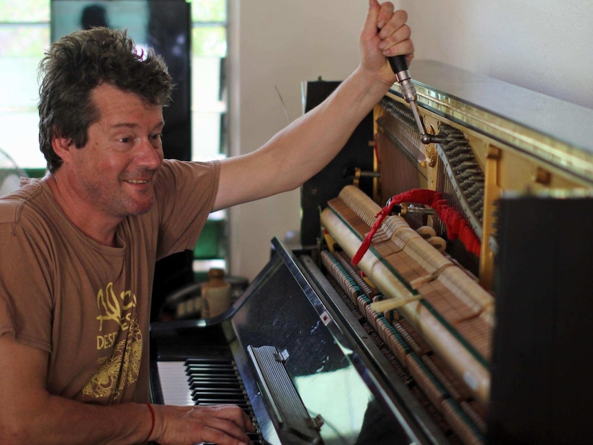 A man tuning a piano.