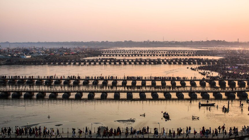 Hindu pilgrims make their way over pontoon bridges near Sangam during the Kumbh Mela festival.