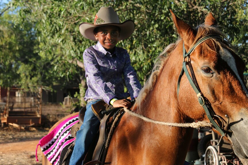 LANDLINE: A young girl sits on her horse at the Borroloola rodeo