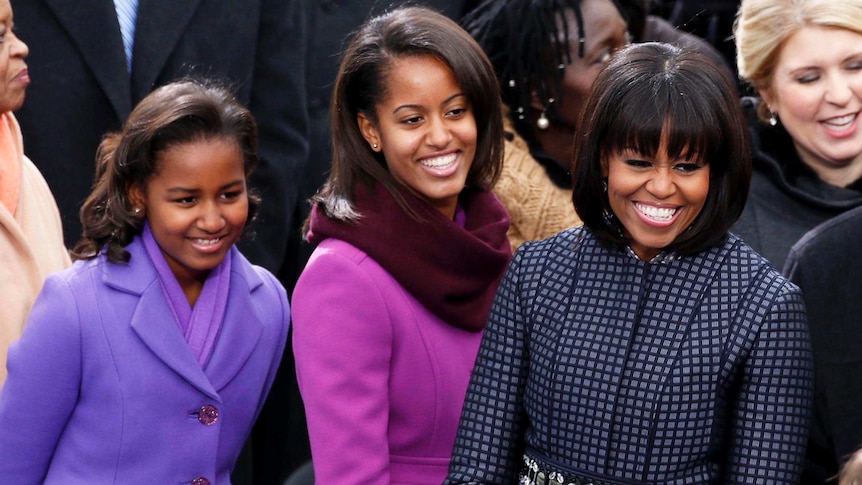 LtoR Sasha, Malia and Michelle Obama smile at the inauguration ceremonies.