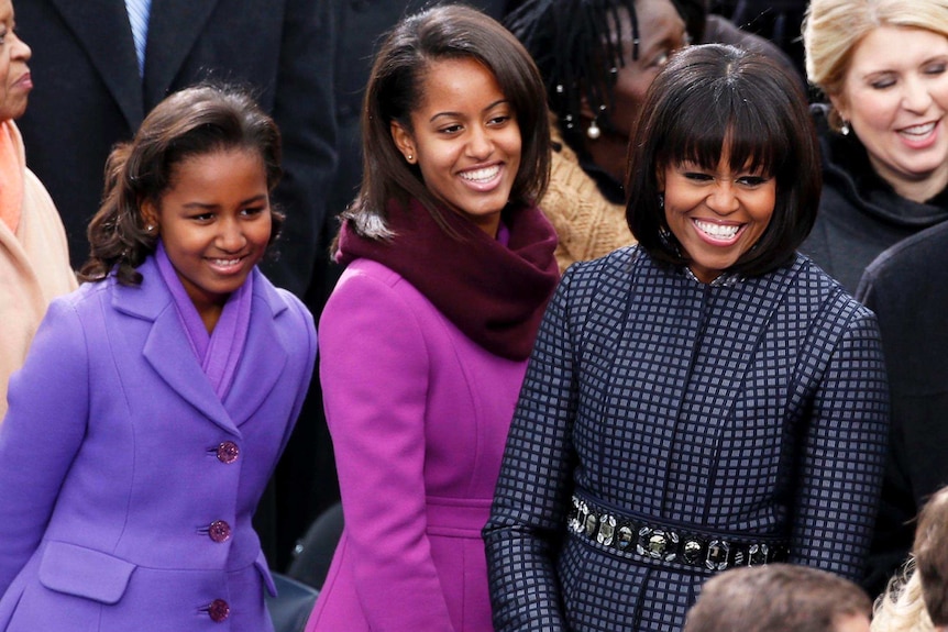 LtoR Sasha, Malia and Michelle Obama smile at the inauguration ceremonies.