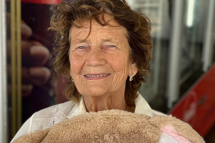 A photo of an elderly woman, smiling at a camera