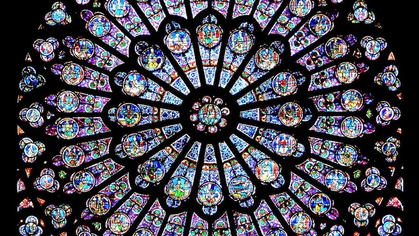 The Notre Dame's rose windows lit up from behind.