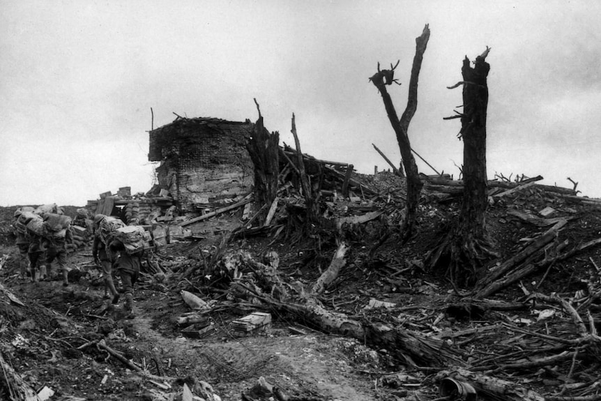 An Australian fatigue party from the Australian pass a former German bunker at the western end of Pozieres.