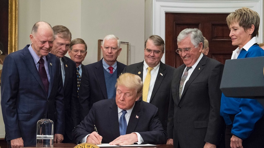 President Donald Trump joined by representatives of Congress and the National Space Council in signing space policy directive