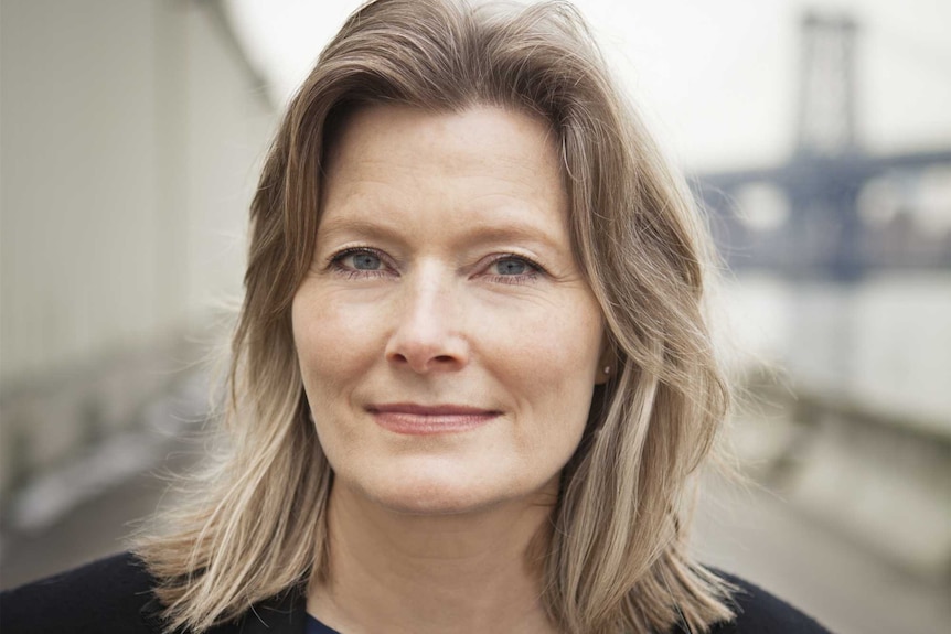 The novelist Jennifer Egan standing outside, bridge in background