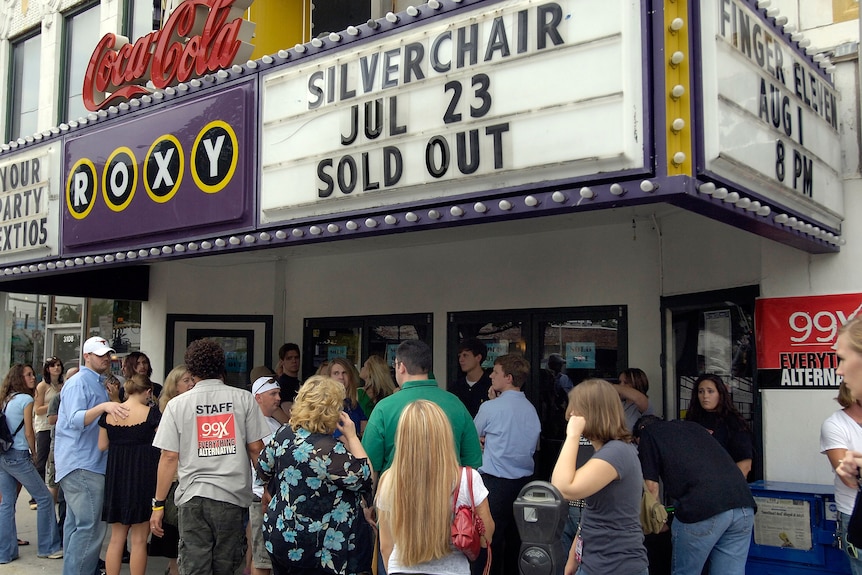 Crowds line up outside music venue. Sign states Silverchair July 23 sold out 