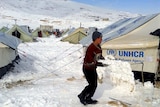 A young Syrian plays with snow following a storm in the town of Arsal in the Lebanese Bekaa Valley.