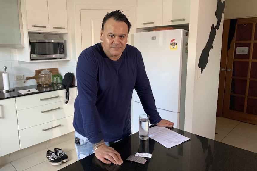 Johnny Skinner leans against the bench in his kitchen.