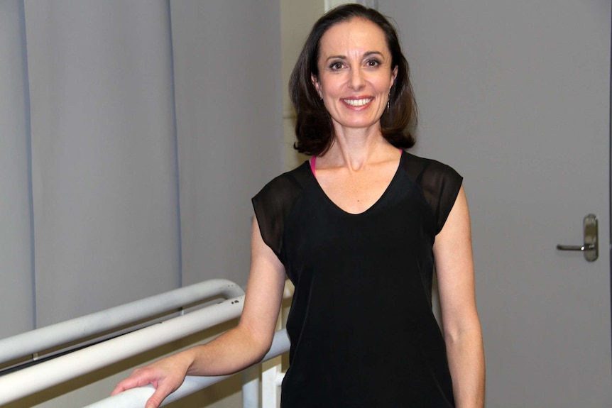 Ballet Teacher Fiona Gaske stands at barre