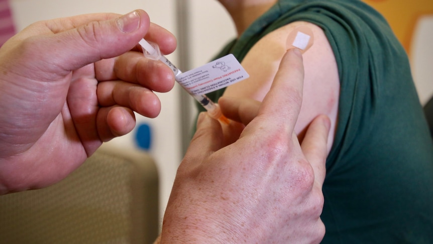 A COVID vaccination being administered to a young child.