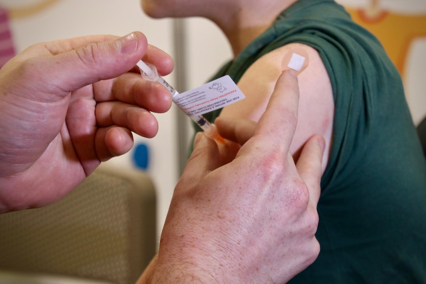 A COVID vaccination being administered to a young child.