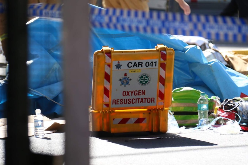 An oxygen resuscitator is seen as paramedics treat those injured.