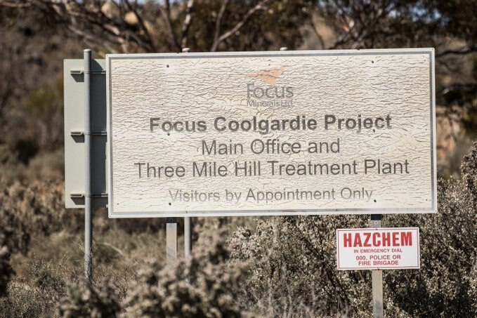 A sign on the side of the road at entrance to a gold mining operation.