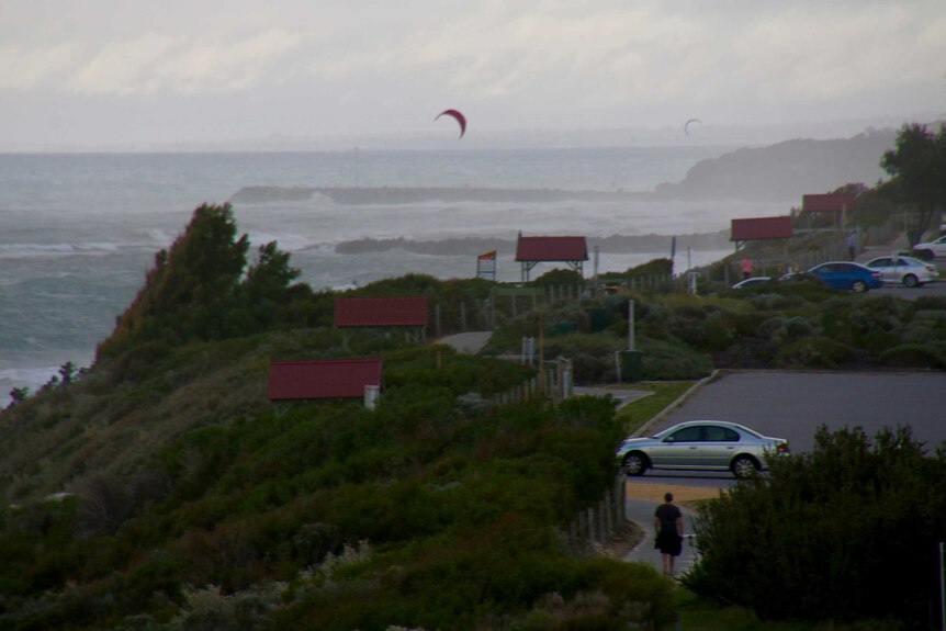 Kite surfers take advantage of windy conditions at Leighton Beach as stormy weather approaches.