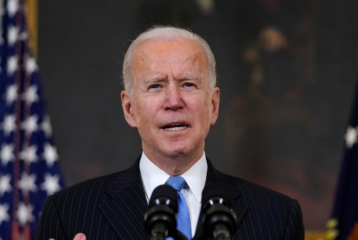 President Joe Biden speaks about efforts to combat COVID-19 from behind a podium