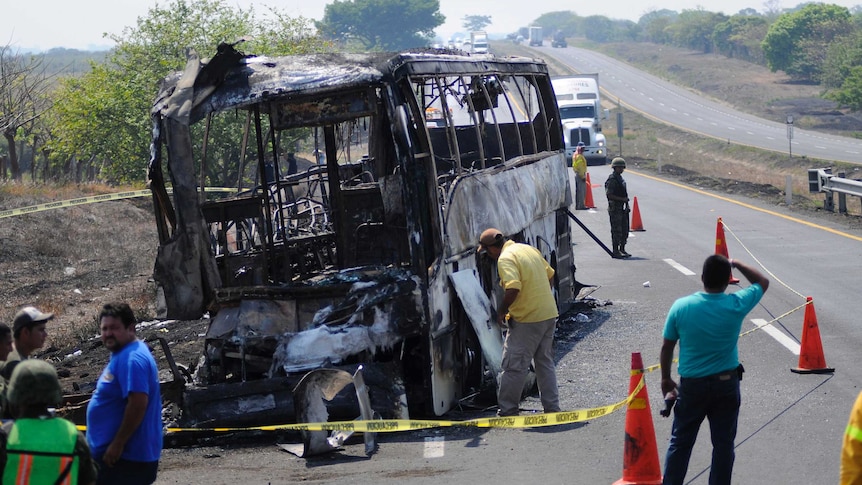 The burnt out remains of a bus sit on a highway near Juan Rodriguez Clara in Mexico.
