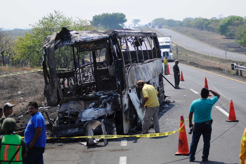 The burnt out remains of a bus sit on a highway near Juan Rodriguez Clara in Mexico.