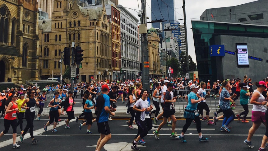 Melbourne marathon participants run past Federation Square on October 18, 2015.