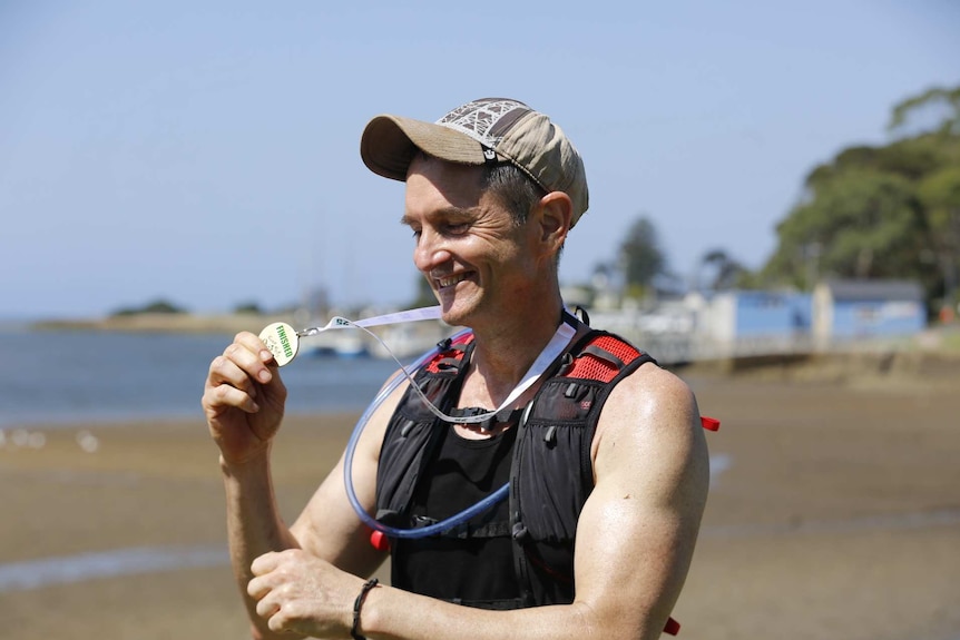 O'Brien holding medal.