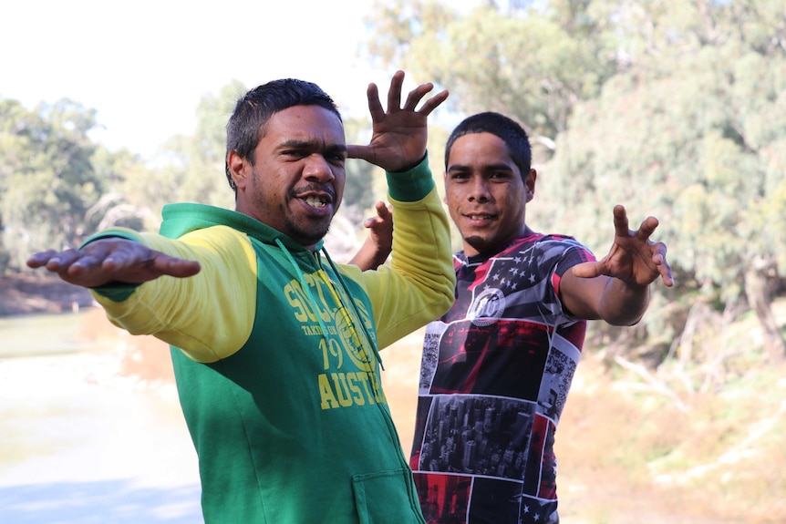 Photo of Colroy and Lendal from The Wilcannia Mob, standing side-by-side, outside.