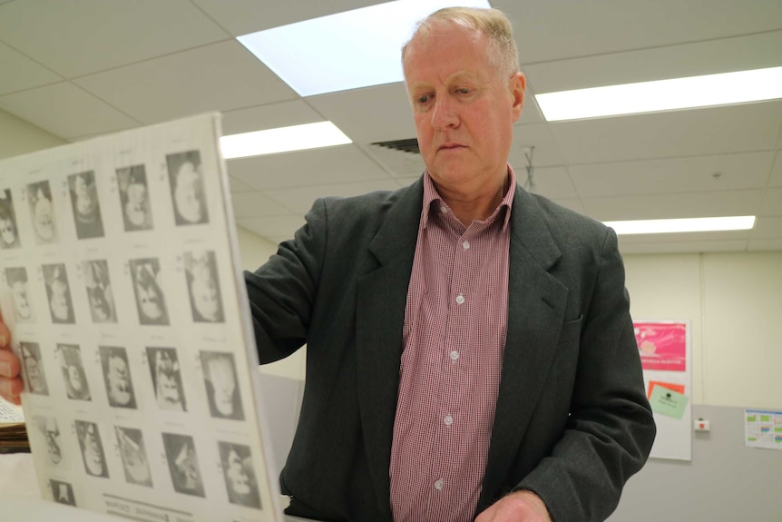 Manager of the State Library Victoria's Manuscripts Collection, Kevin Molloy, reads of roll book of 19th century Ballarat miners