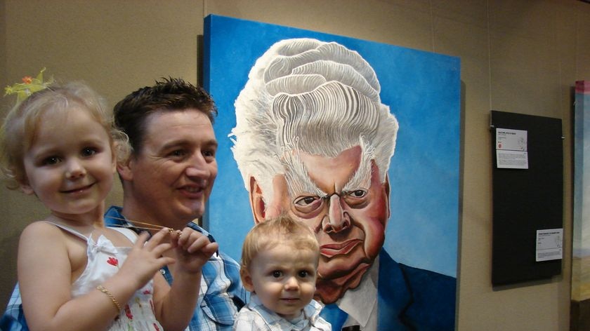 James Brennan and his children Charlotte and Darcy celebrate in front of the winning Bart Cummings portrait.