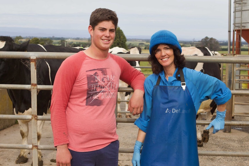 Leanne stands with her son near their cows