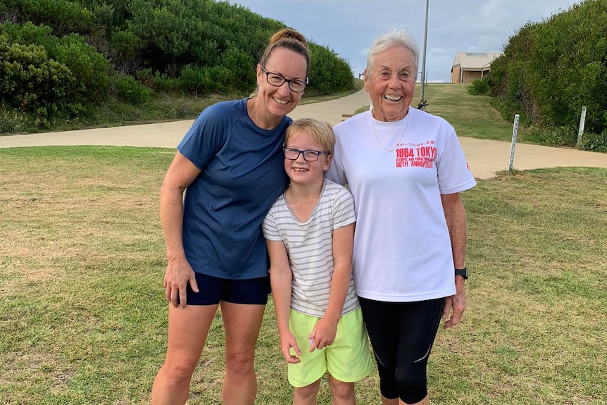 Judy Amoore Pollock and her daughter and grandson huddle together for a photo.