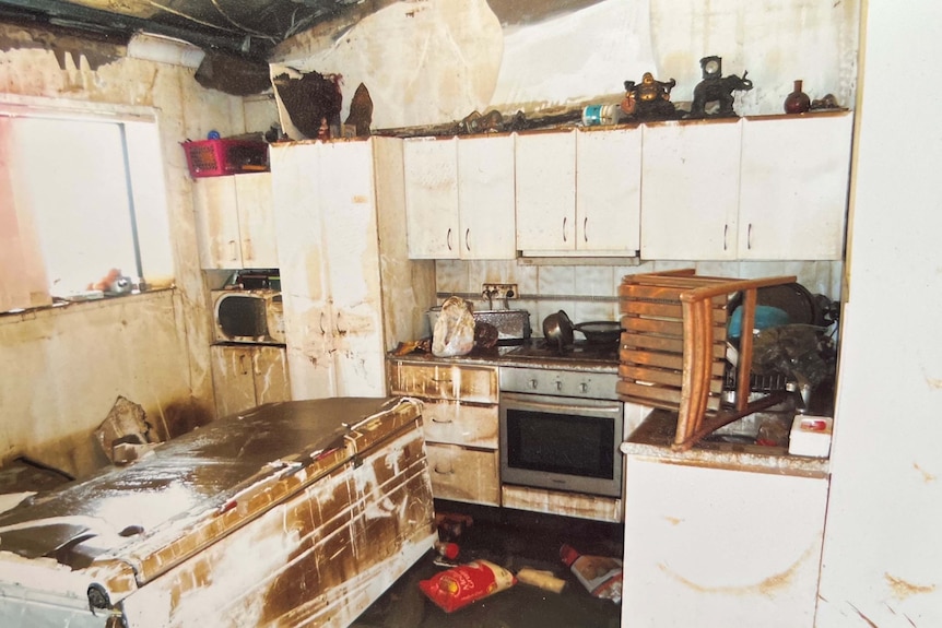 A kitchen with mud and debris everywhere.