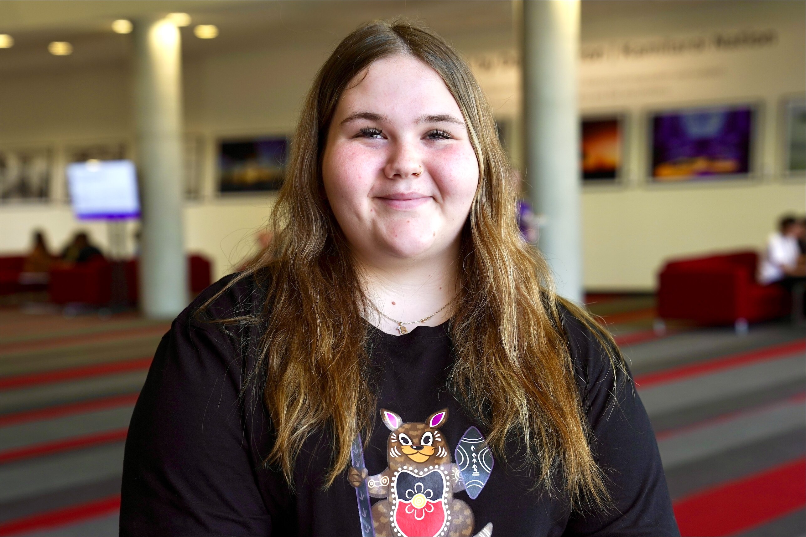 Miah has blonde hair and a black t shirt