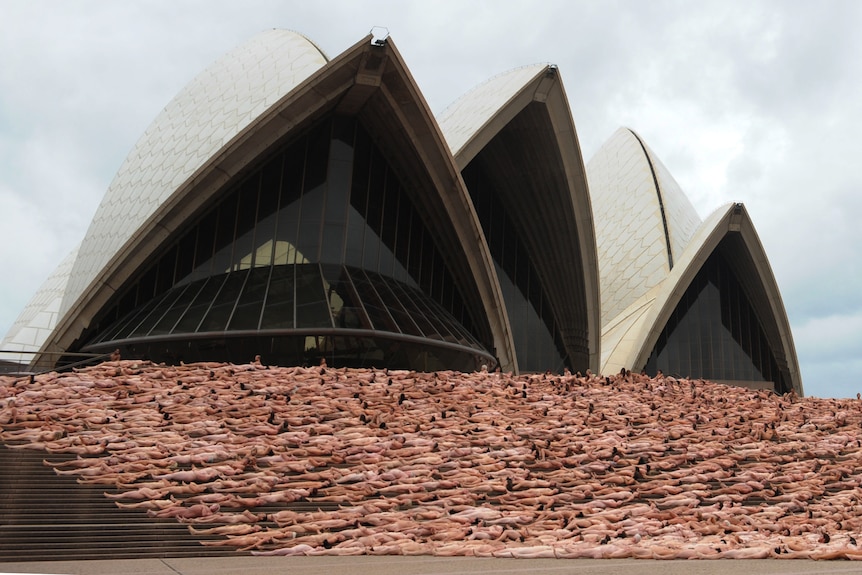 more than five thousand people in the nude lie on the steps of the opera house in sydney for a photo shoot for spencer tunick