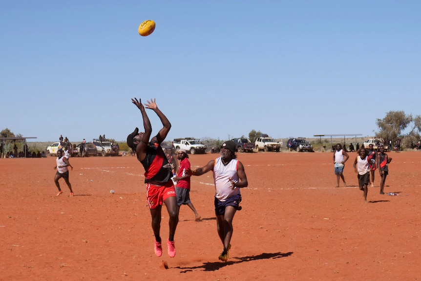 A man jumping to catch a football