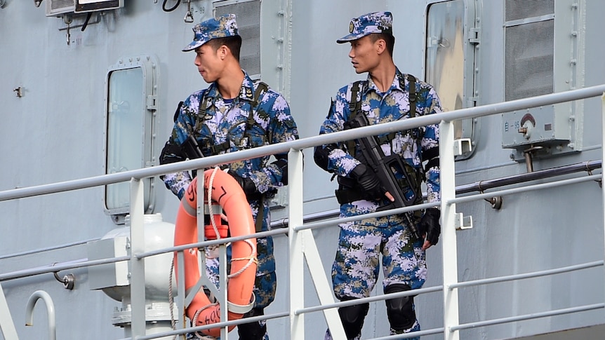 Chinese Navy personnel are seen onboard a Chinese Navel ship after it arrives at Garden Island Naval Base in Sydney.