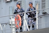 Chinese Navy personnel are seen onboard a Chinese Navel ship after it arrives at Garden Island Naval Base in Sydney.