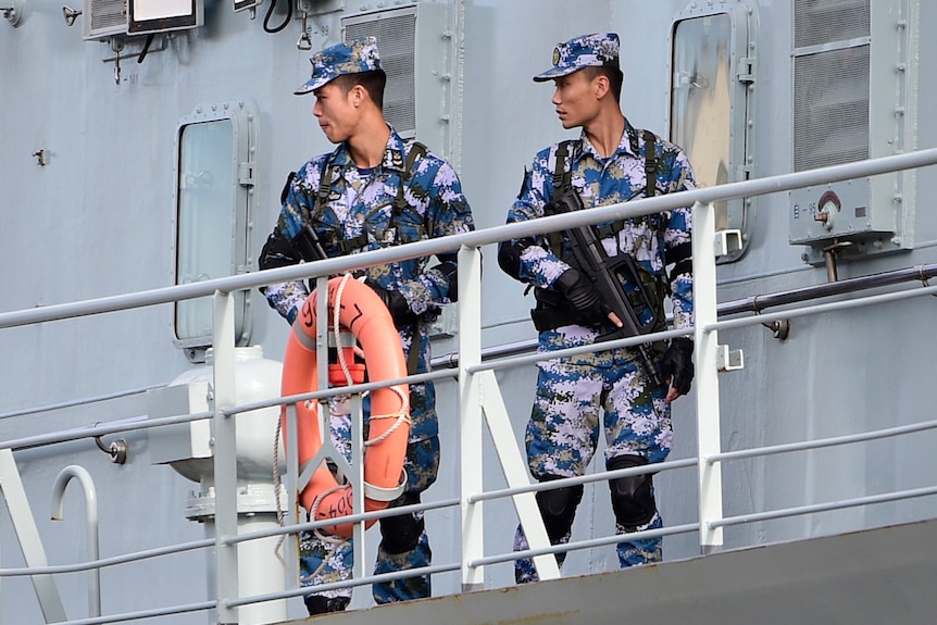 Chinese Navy personnel are seen onboard a Chinese Navel ship after it arrives at Garden Island Naval Base in Sydney.