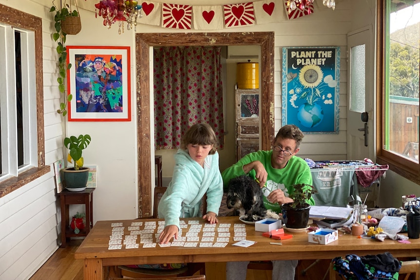 Father and daughter work on puzzle at home