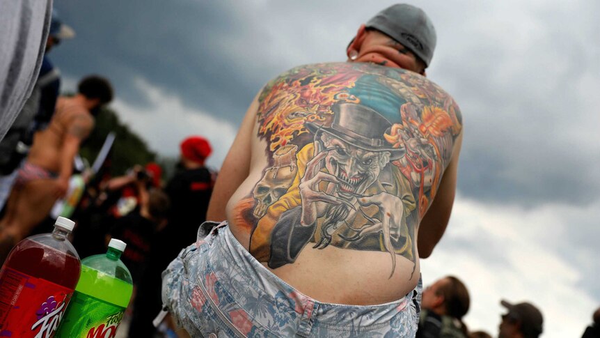 A demonstrator at the march dons a full coloured back tattoo
