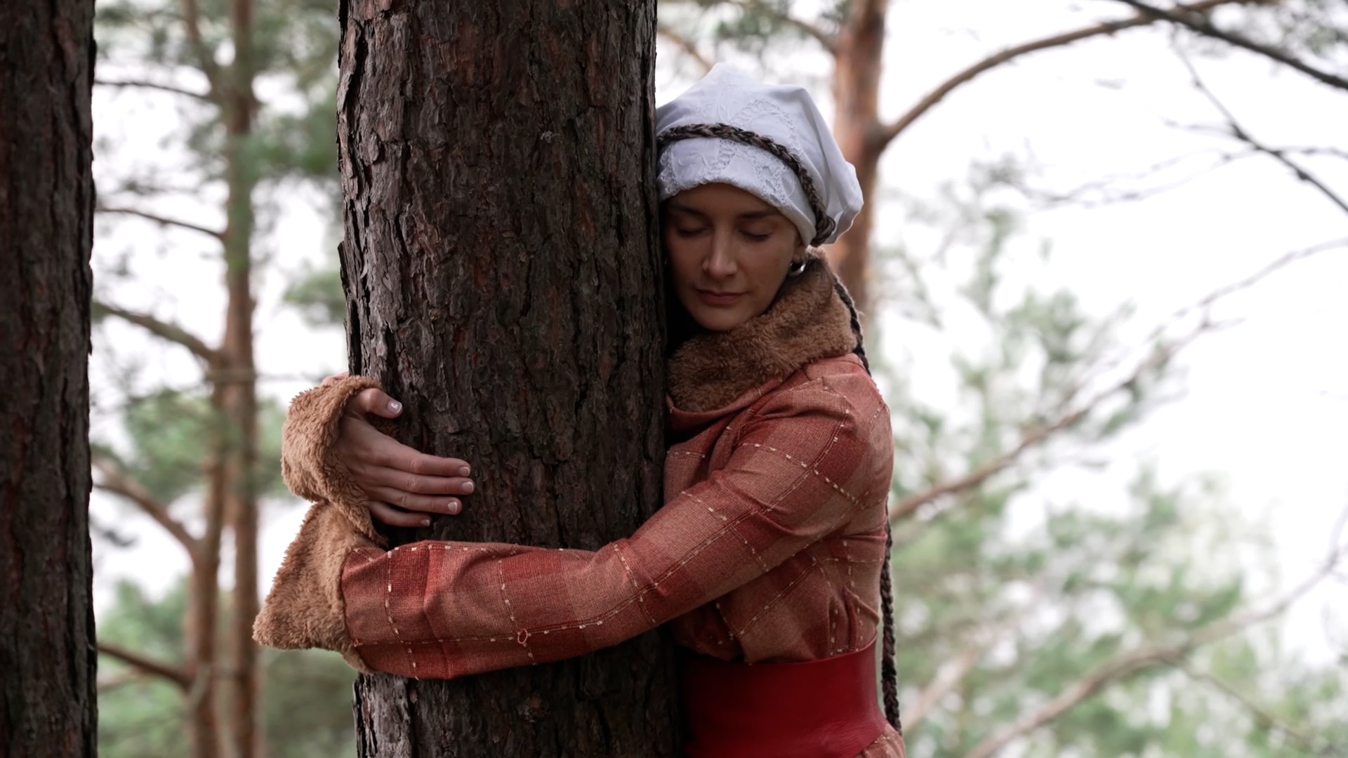 Lucinda hugs a tree.