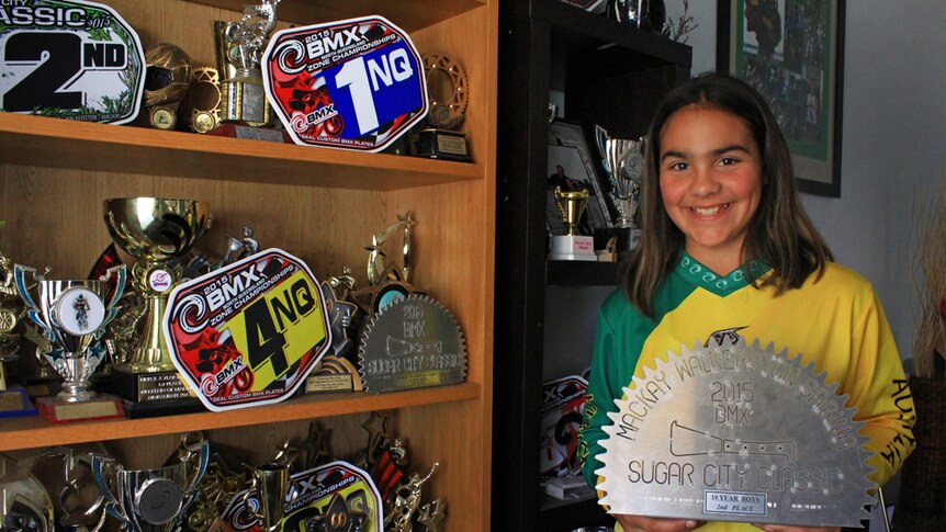 Chelsea McLeod pictured next to the trophy cabinet inside her Glenden home