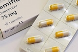 Tamiflu capsules sit on a bench in a pharmacy
