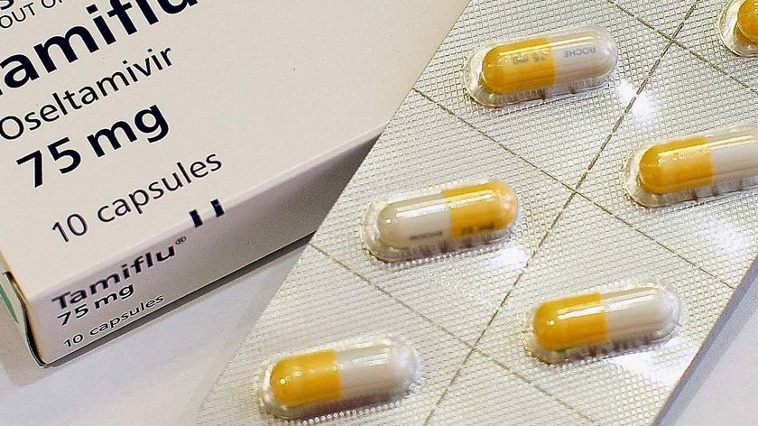Tamiflu capsules sit on a bench in a pharmacy
