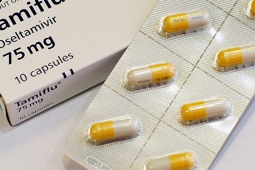 Tamiflu capsules sit on a bench in a pharmacy