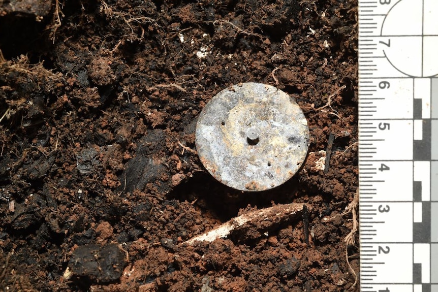 A metal item in the dirt