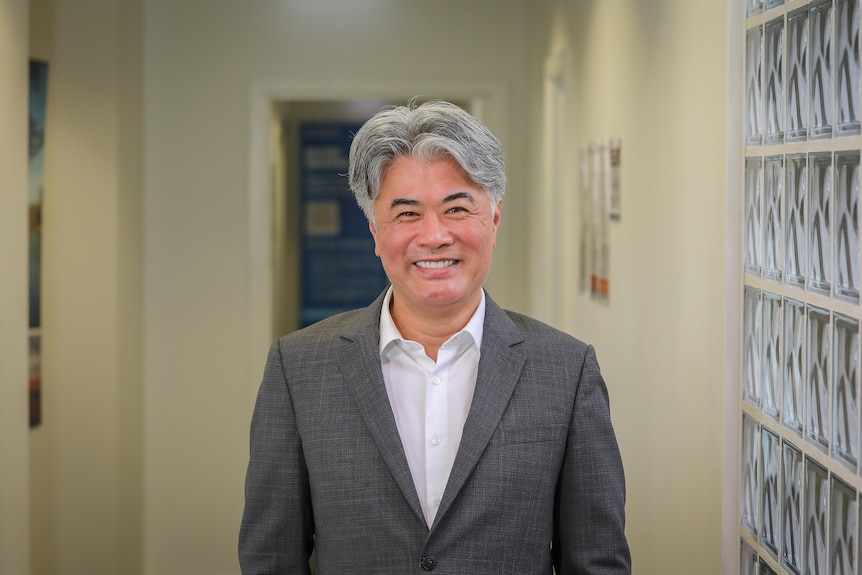 Grey haired man in grey suit