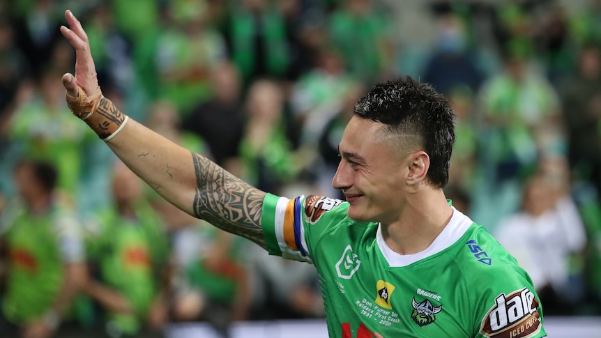 A man waves to the crowd after a rugby league match