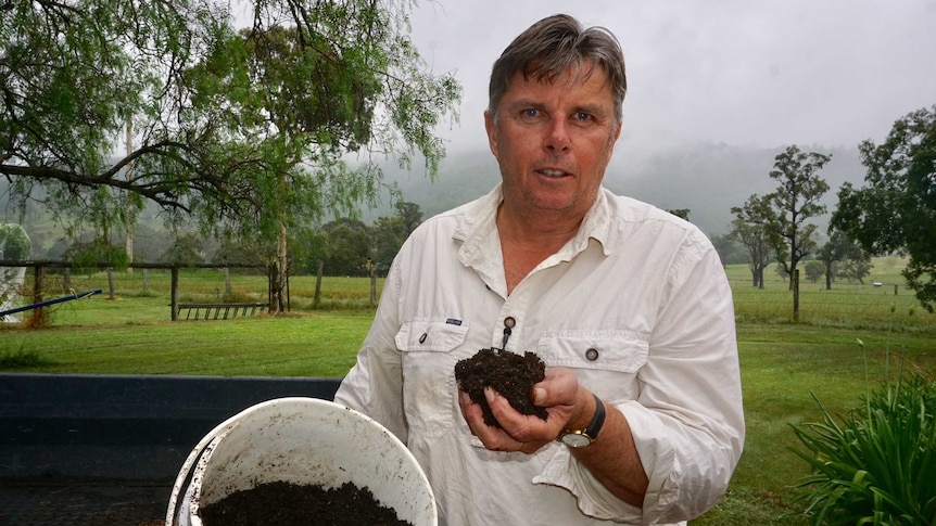 Russell Brown holds some of the treated household waste in his hand.