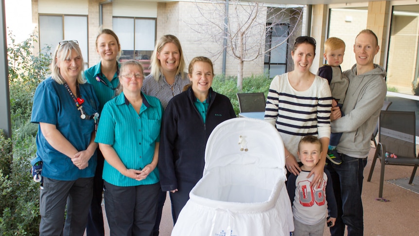 Midwives and the Cousins family with the cuddle cot.
