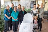 Midwives and the Cousins family with the cuddle cot.