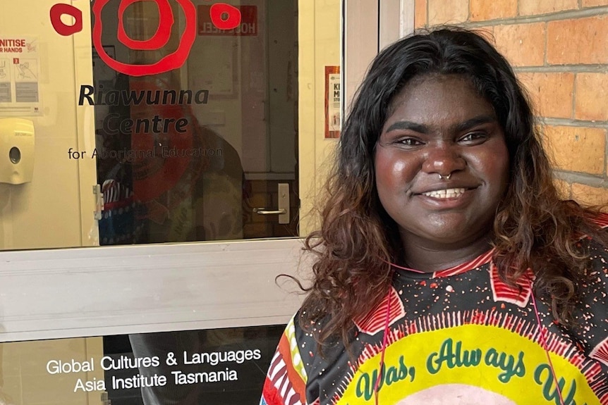 a smiling Aboriginal woman smiling with her thumb up